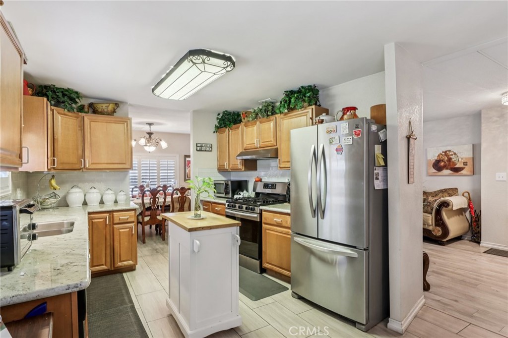 3700 Buchanan Street, Unit 28 Riverside, CA 92503 - Photo 16 of 35 a kitchen with a refrigerator a microwave a sink and cabinets