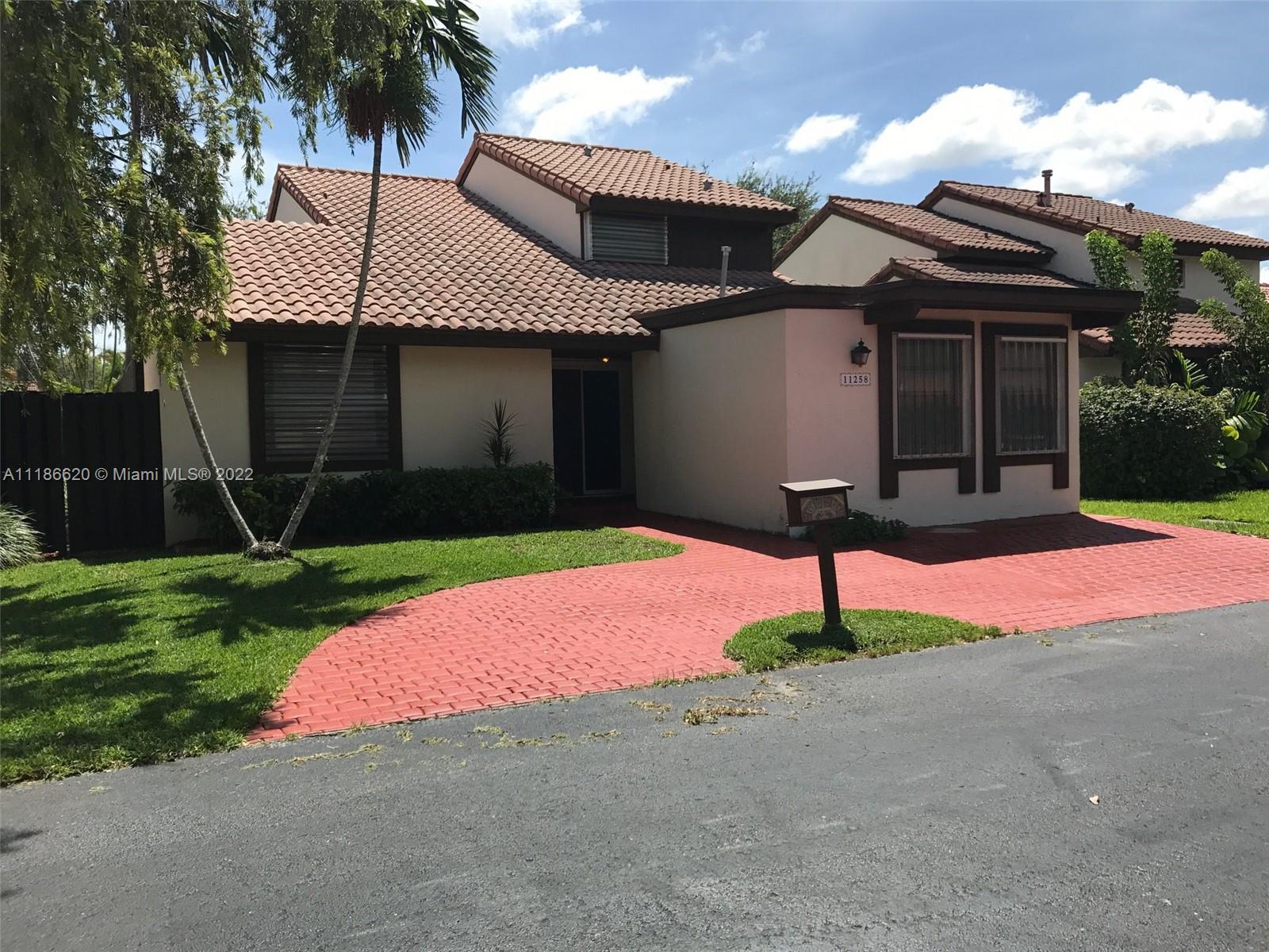 a front view of a house with yard