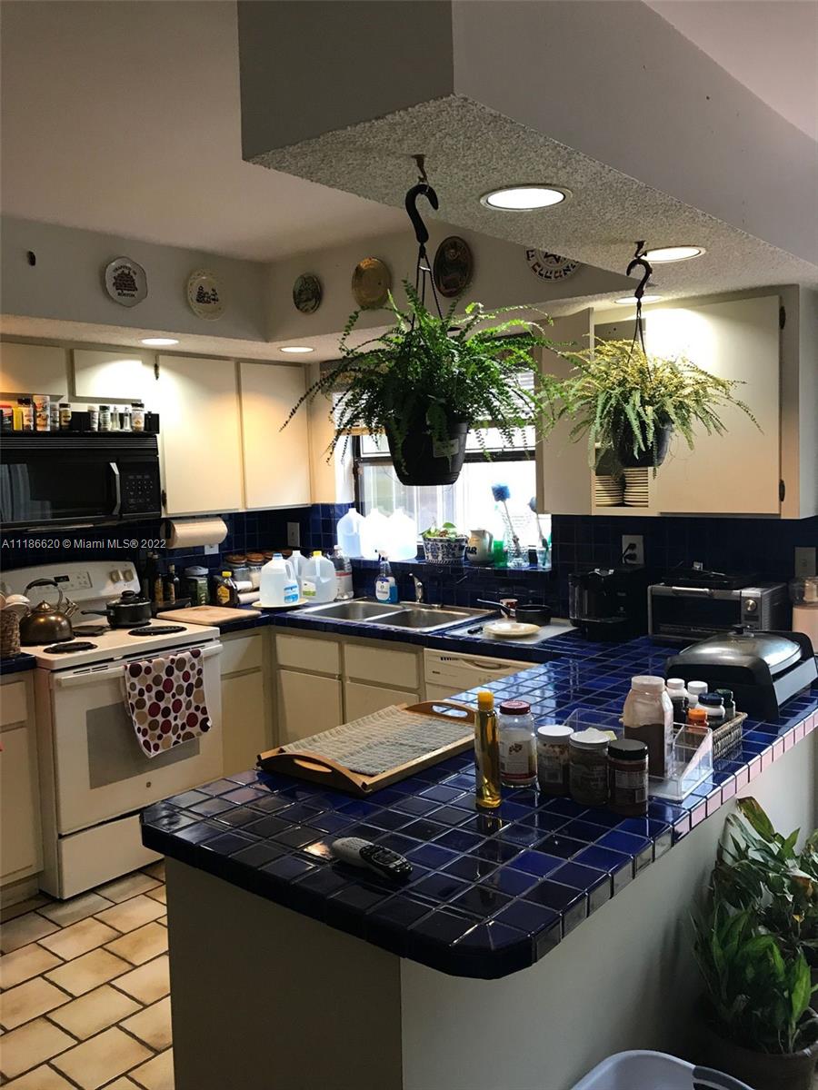 Kendall Miami, FL 33176 - Photo 11 of 15 a kitchen with stainless steel appliances granite countertop a sink a stove and a microwave