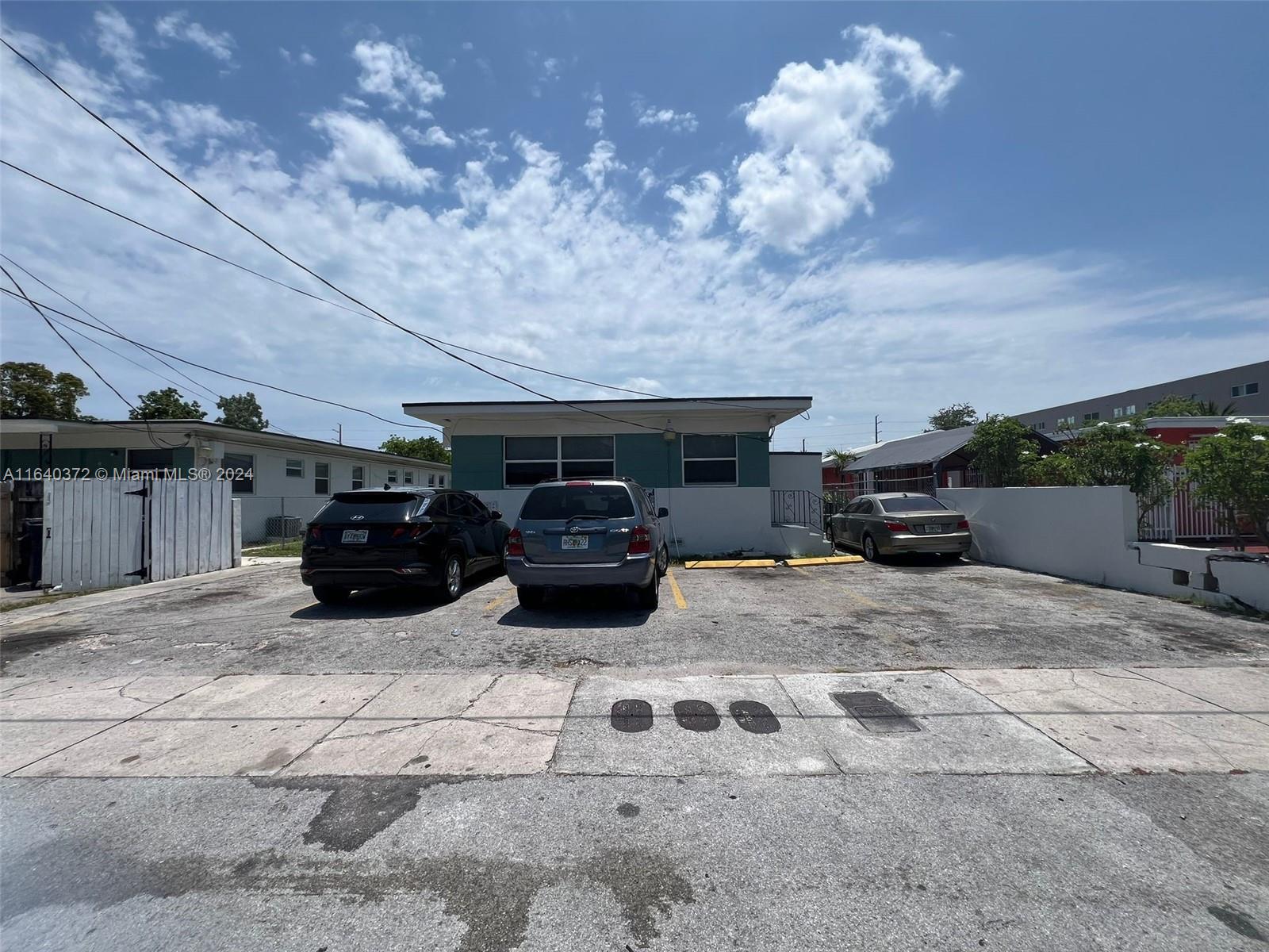 2150 Northwest 24th Street Miami, FL 33142 - Photo 3 of 18 a car parked in parking lot