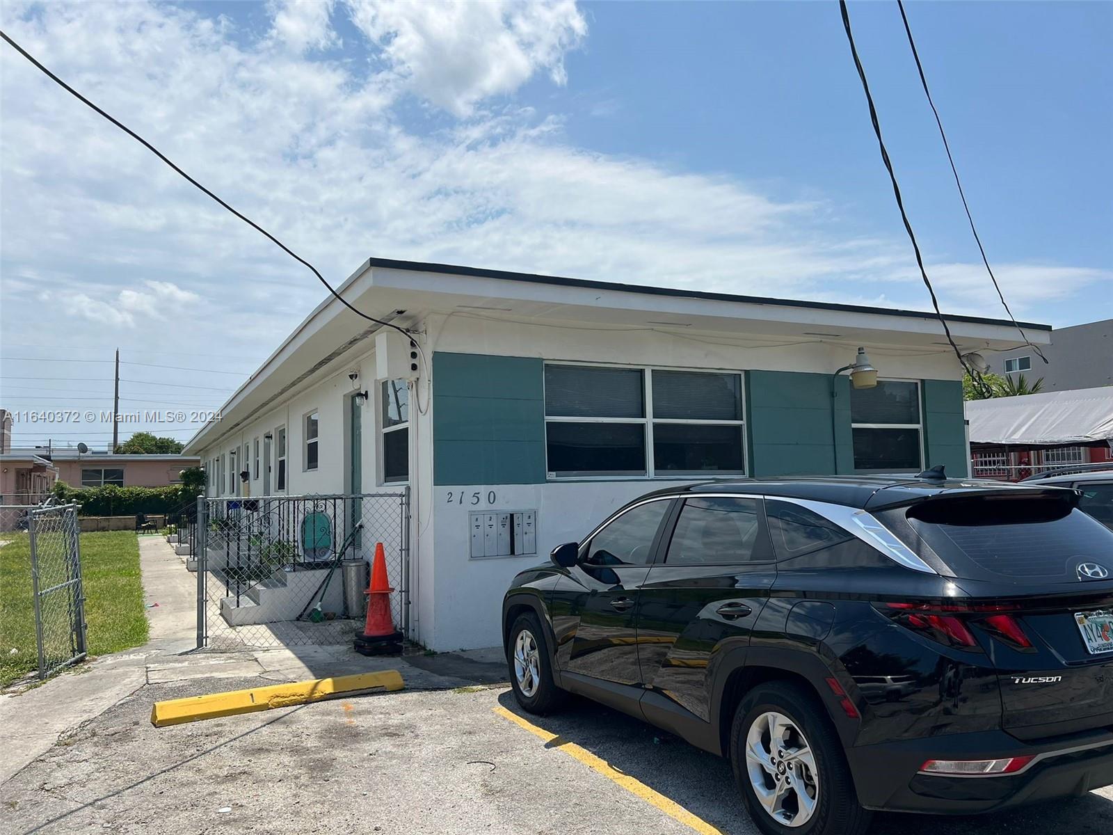 2150 Northwest 24th Street Miami, FL 33142 - Photo 5 of 18 a car parked in front of a house