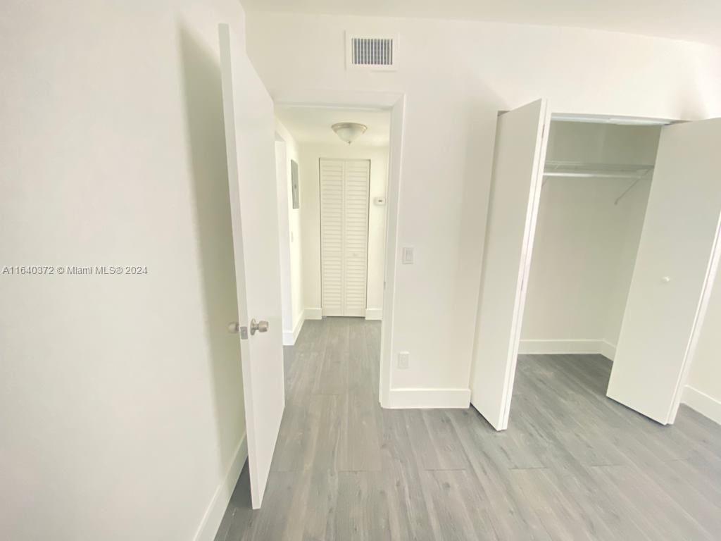 2150 Northwest 24th Street Miami, FL 33142 - Photo 9 of 18 a view of a room with wooden floor