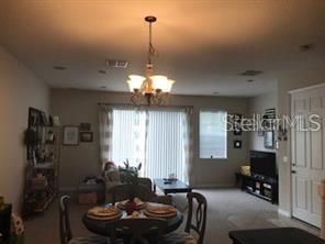 5097 Cypress Branch Point Oviedo, FL 32765 - Photo 3 of 8 a living room with furniture and a chandelier