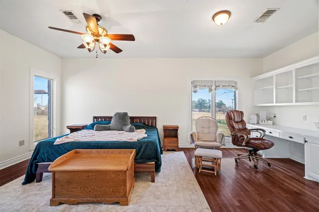 a work room with furniture and wooden floor