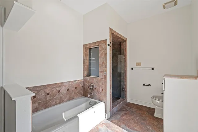 a bathroom with a bathtub and a shower
