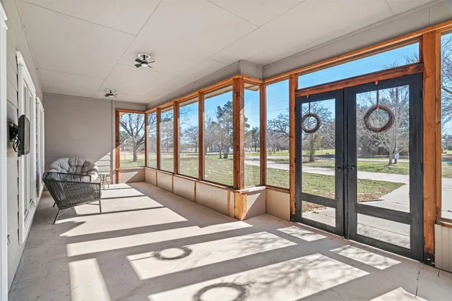 a spacious bedroom with a large bed and a large window