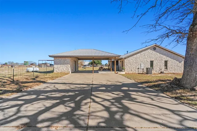 a view of a house with wooden fence