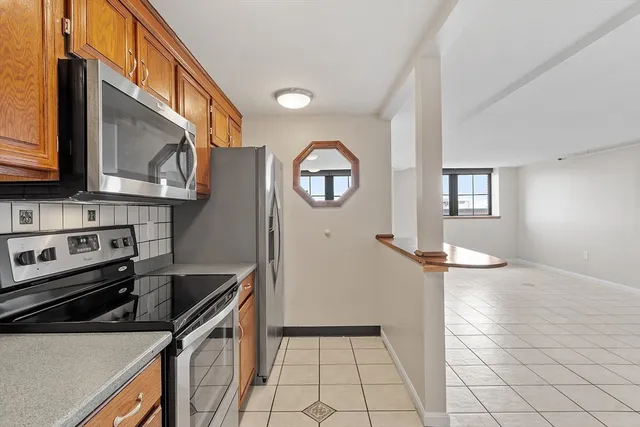 a kitchen with granite countertop a stove and a sink