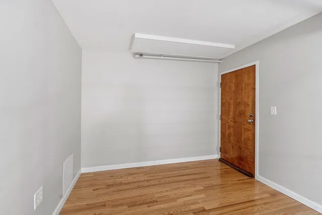 a view of room with wooden floor