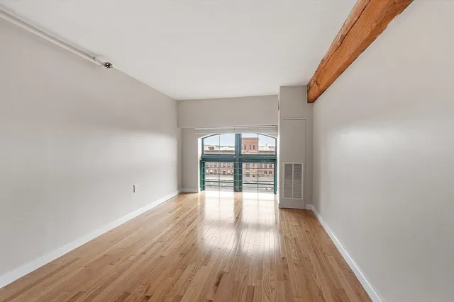 a view of walk in closet with wooden floor