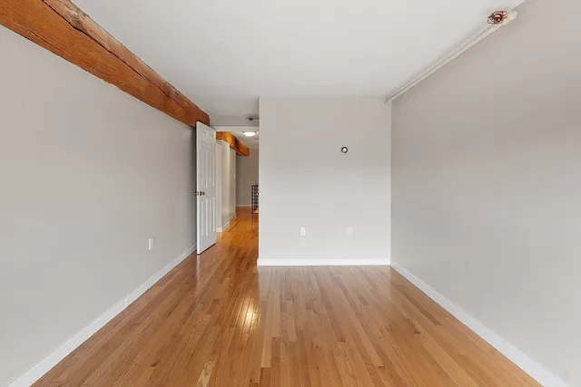 a view of a room with wooden floor