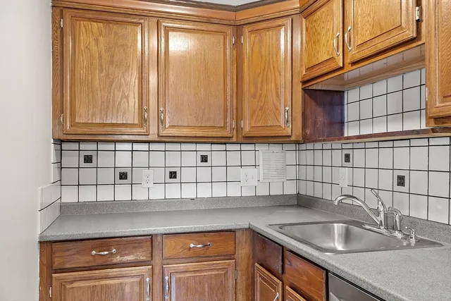 a kitchen with a sink cabinets and a window