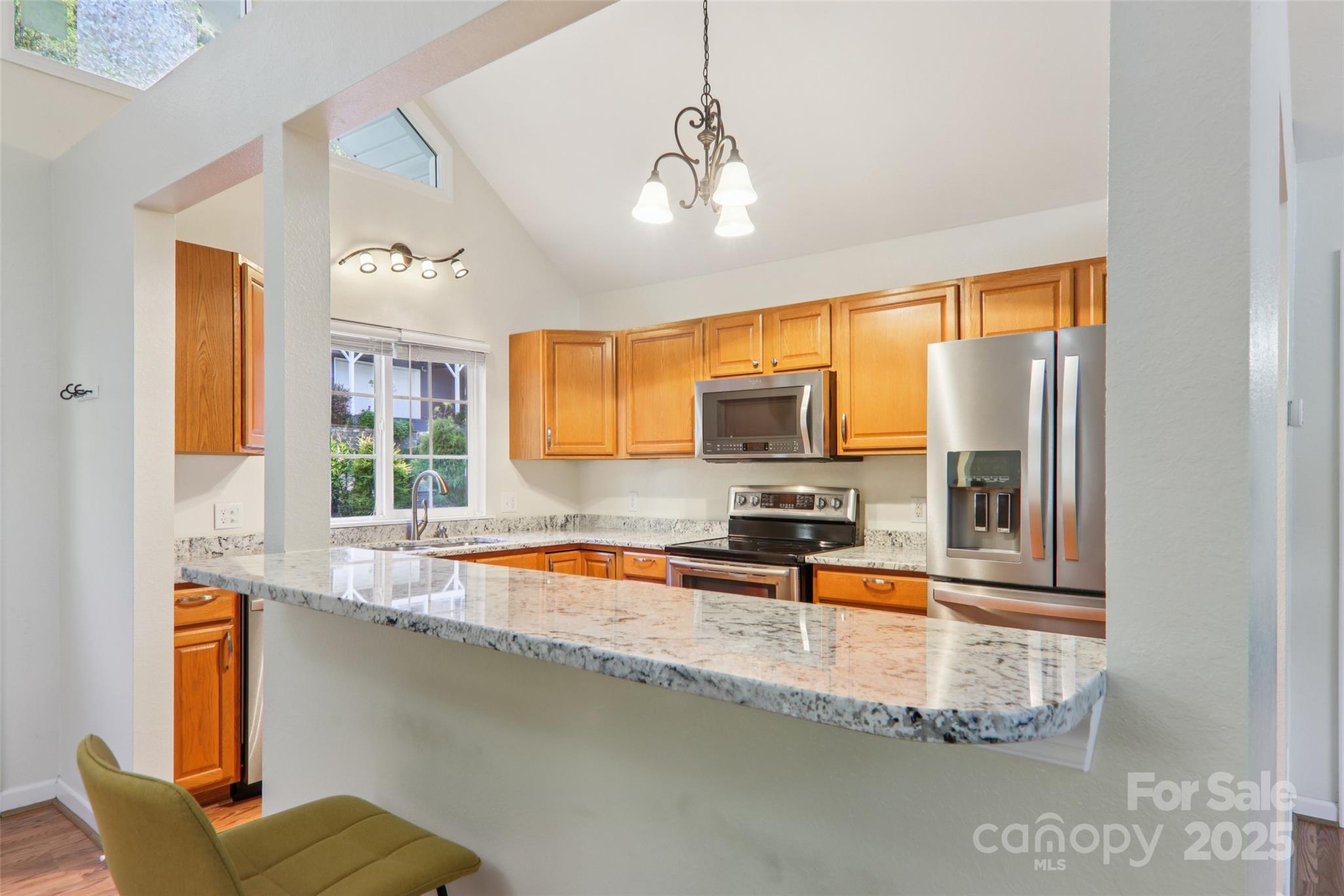 166 Linsonwood Ridge Waynesville, NC 28786 - Photo 12 of 39 a kitchen with stainless steel appliances granite countertop a sink a stove and a microwave
