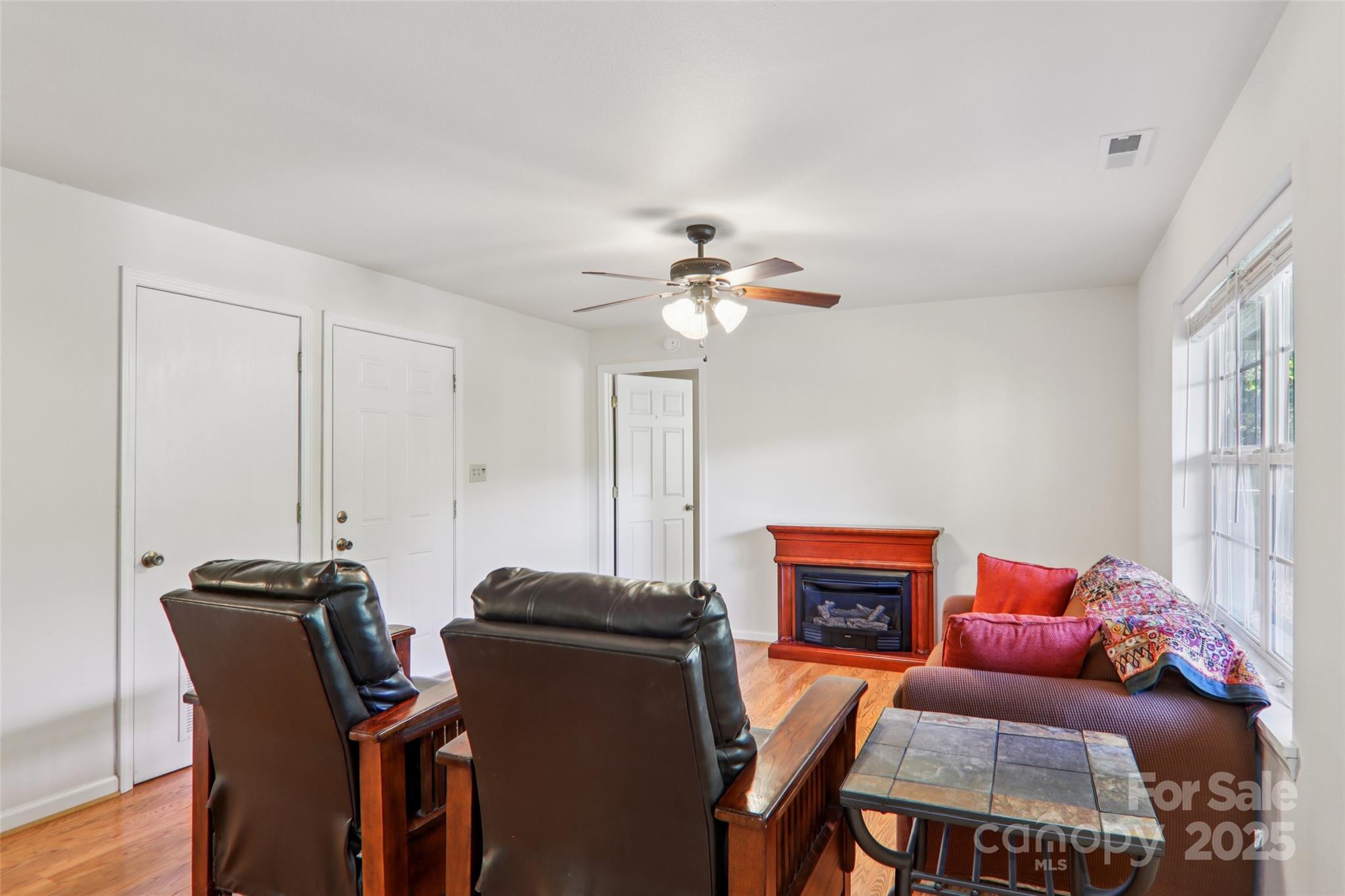 166 Linsonwood Ridge Waynesville, NC 28786 - Photo 18 of 39 a living room with furniture a fireplace and a window