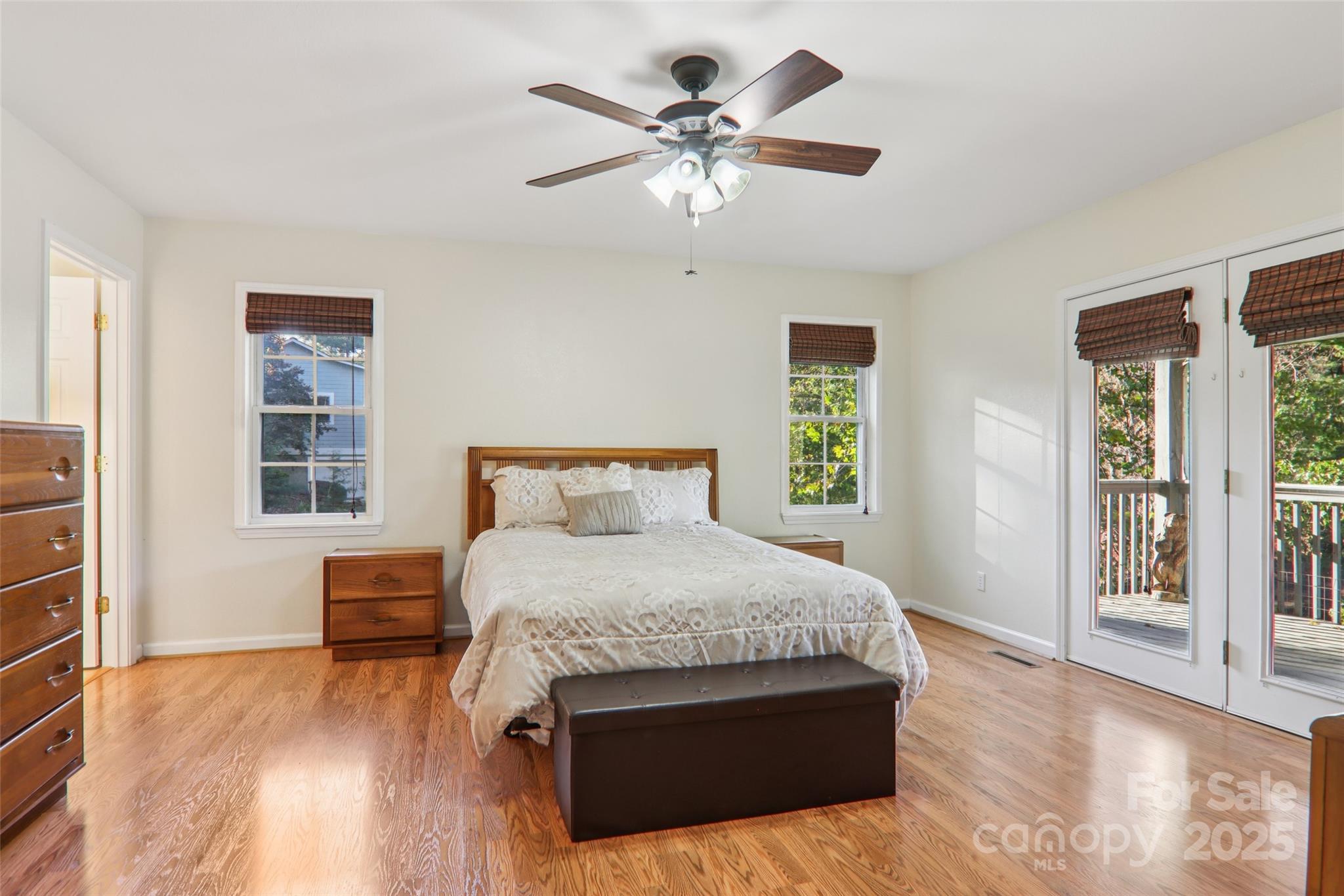 166 Linsonwood Ridge Waynesville, NC 28786 - Photo 22 of 39 a bedroom with a large bed chandelier and a window
