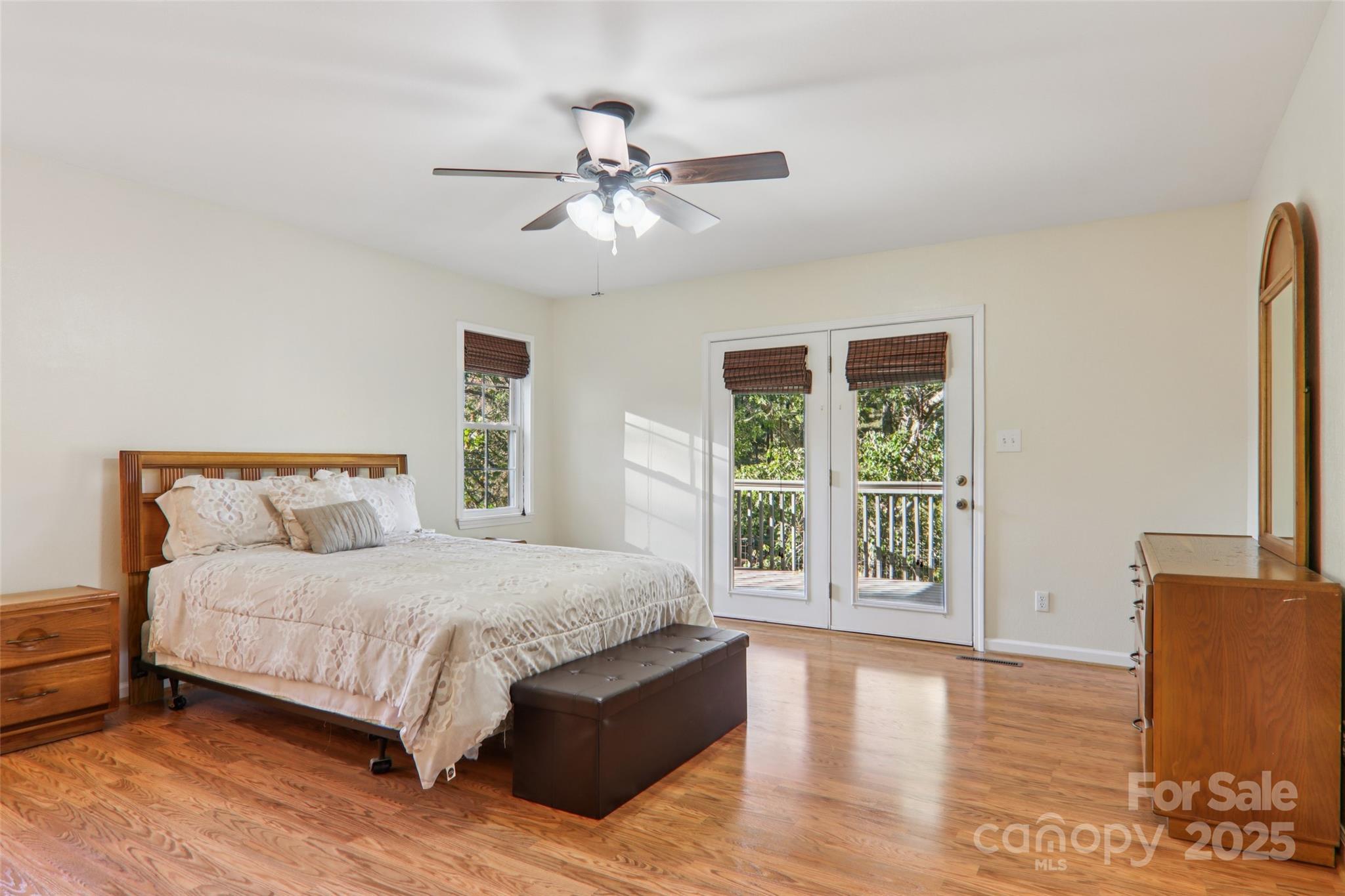 166 Linsonwood Ridge Waynesville, NC 28786 - Photo 24 of 39 a bedroom with a large bed and a large window