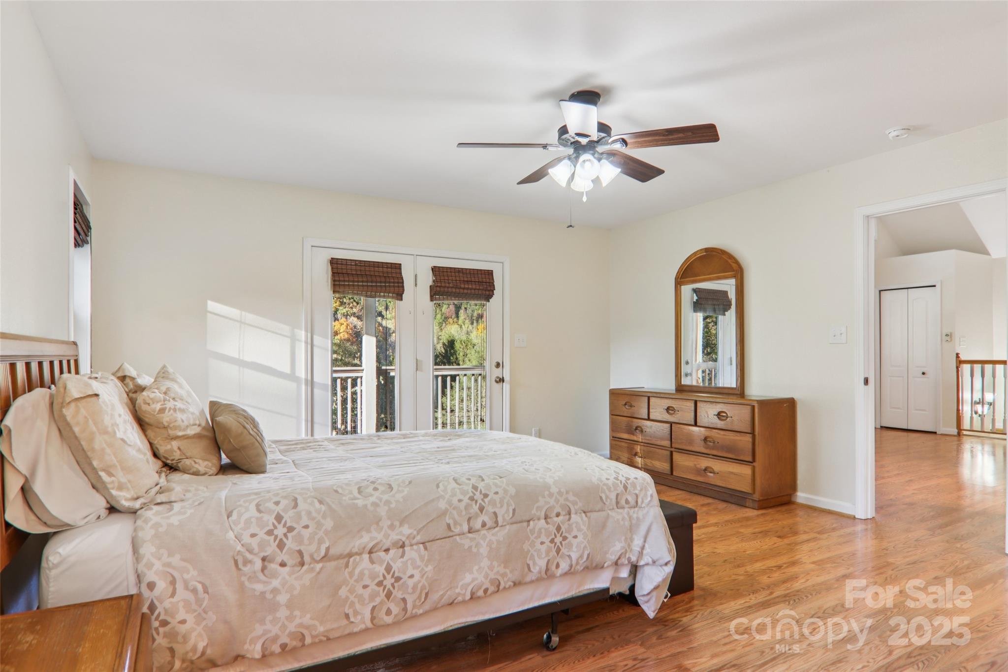 166 Linsonwood Ridge Waynesville, NC 28786 - Photo 25 of 39 a bedroom with a large bed and wooden floor