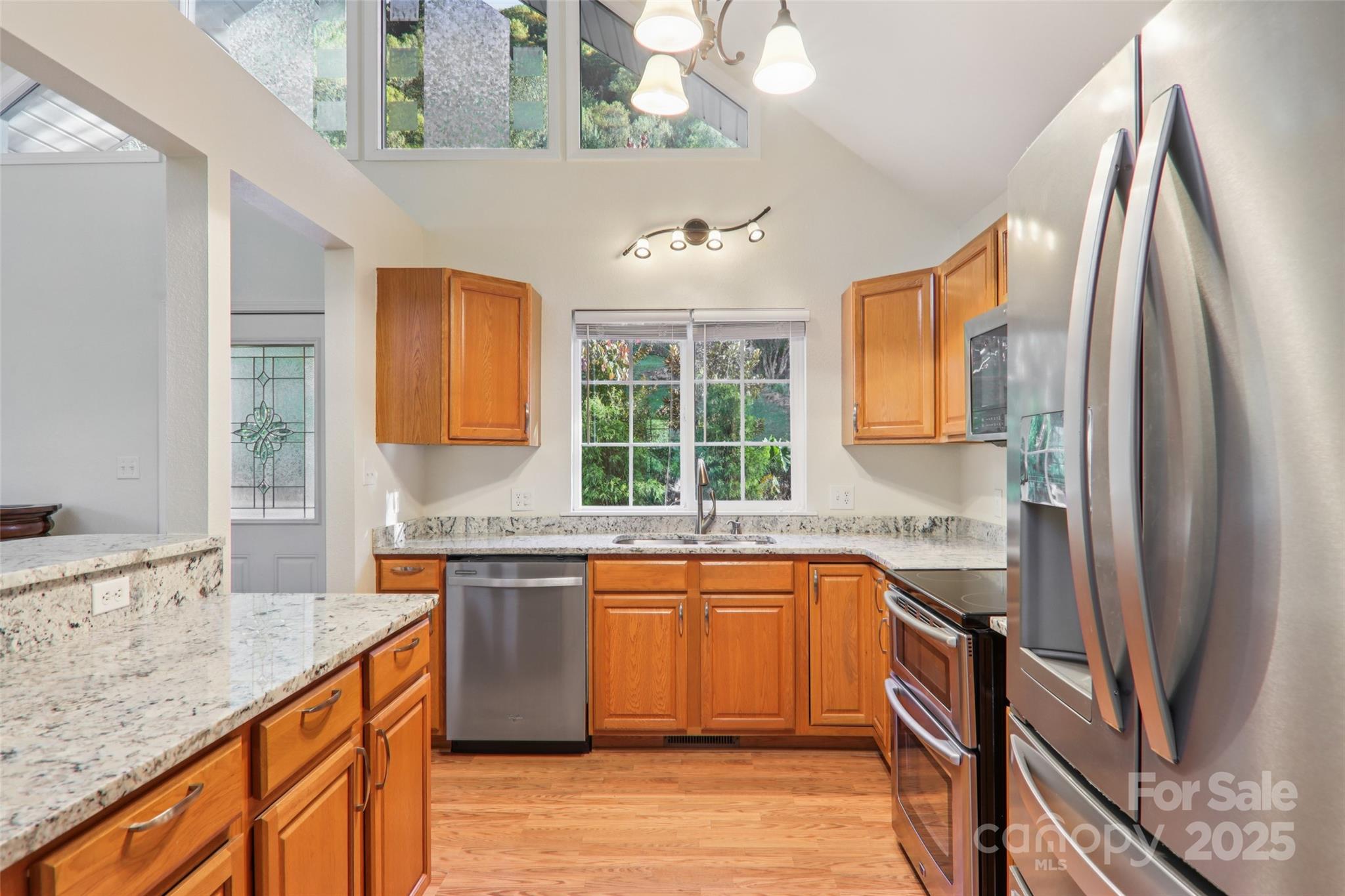 166 Linsonwood Ridge Waynesville, NC 28786 - Photo 9 of 39 a kitchen with stainless steel appliances granite countertop a sink stove and refrigerator