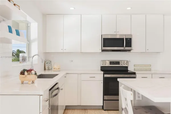 a spacious bedroom with a bed and a flat screen tv