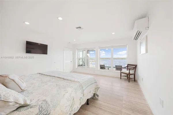 a spacious bedroom with a bed and a window