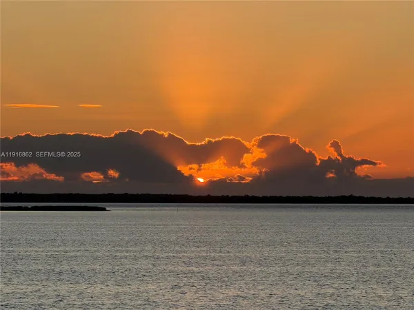 a view of roof deck with dining table and chairs