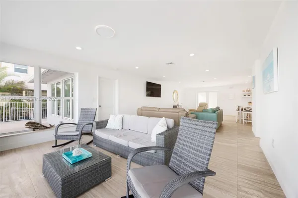 a living room with furniture and kitchen view