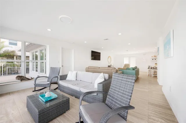 a living room with furniture and kitchen view