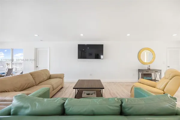 a kitchen with a table chairs refrigerator and microwave