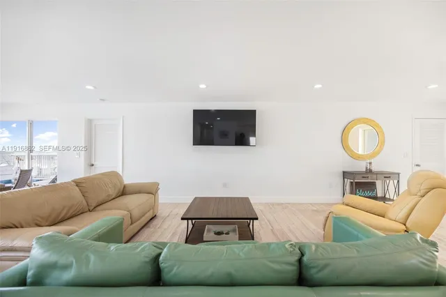 a kitchen with a table chairs refrigerator and microwave