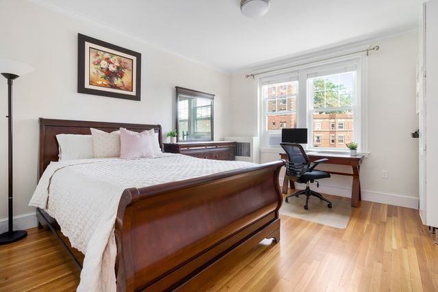 a bedroom with a bed and a desk