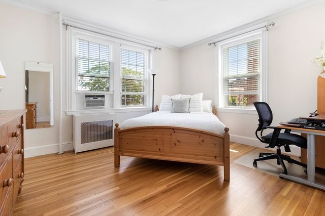 a bedroom with a bed and a desk