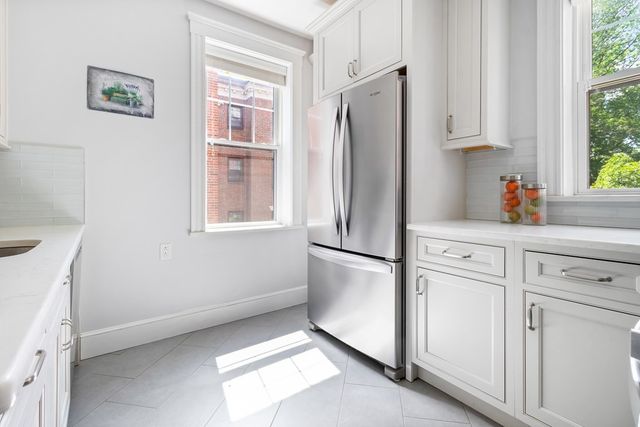 a white refrigerator freezer sitting inside of a kitchen
