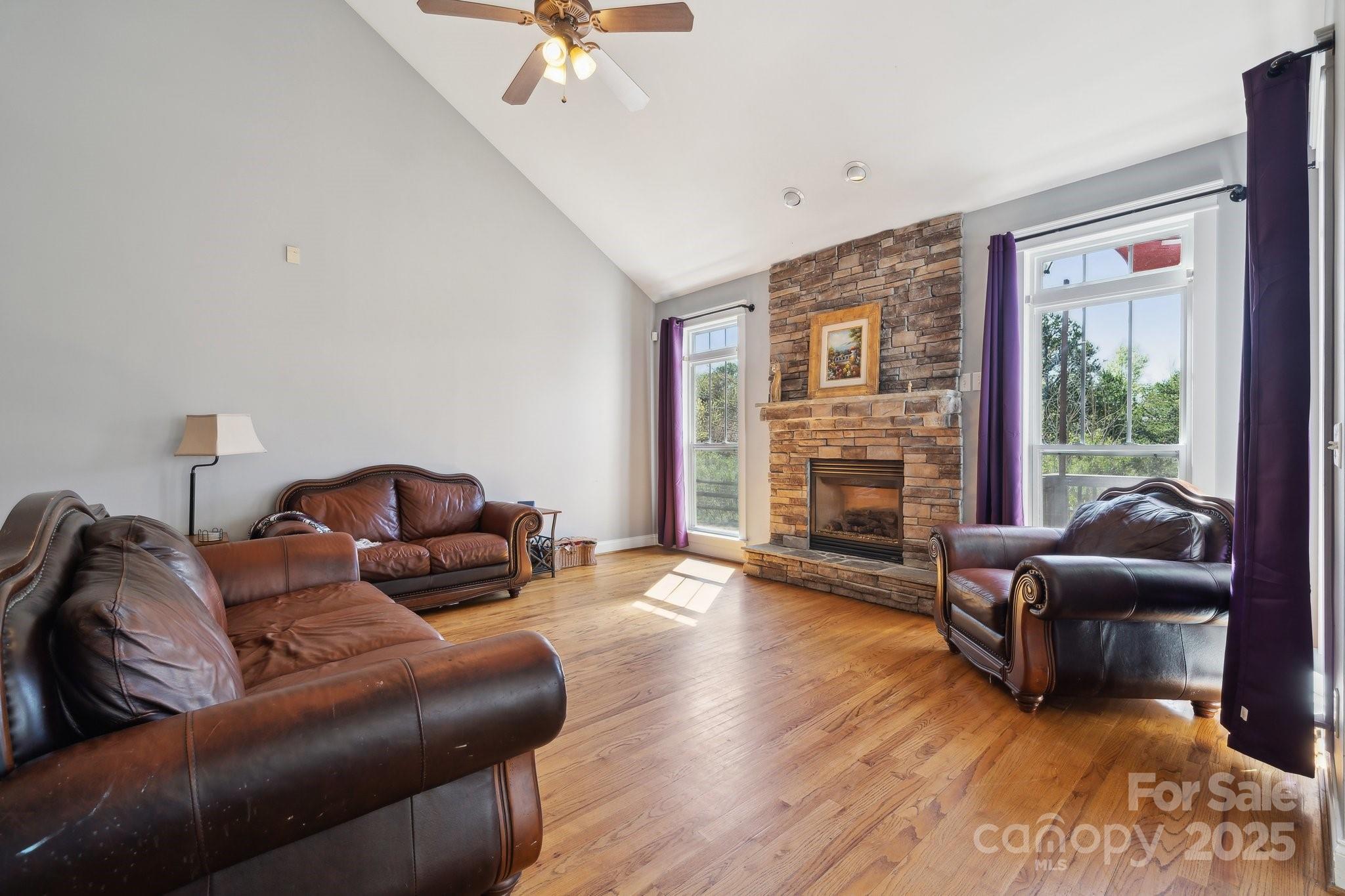 369 Shoreline Parkway Tega Cay, SC 29708 - Photo 11 of 40 a living room with furniture and a fireplace