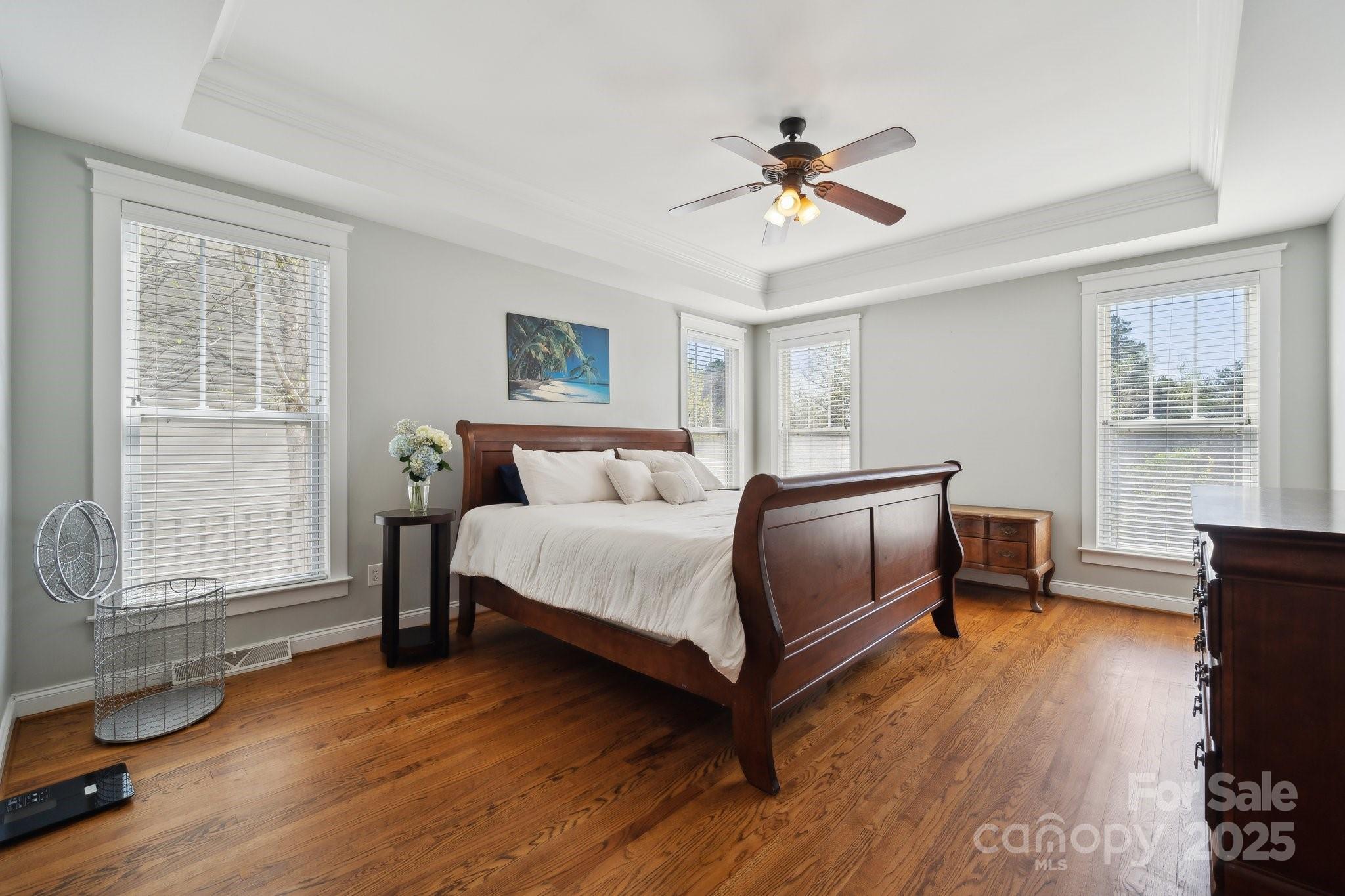 369 Shoreline Parkway Tega Cay, SC 29708 - Photo 16 of 40 a bedroom with a bed and wooden floor