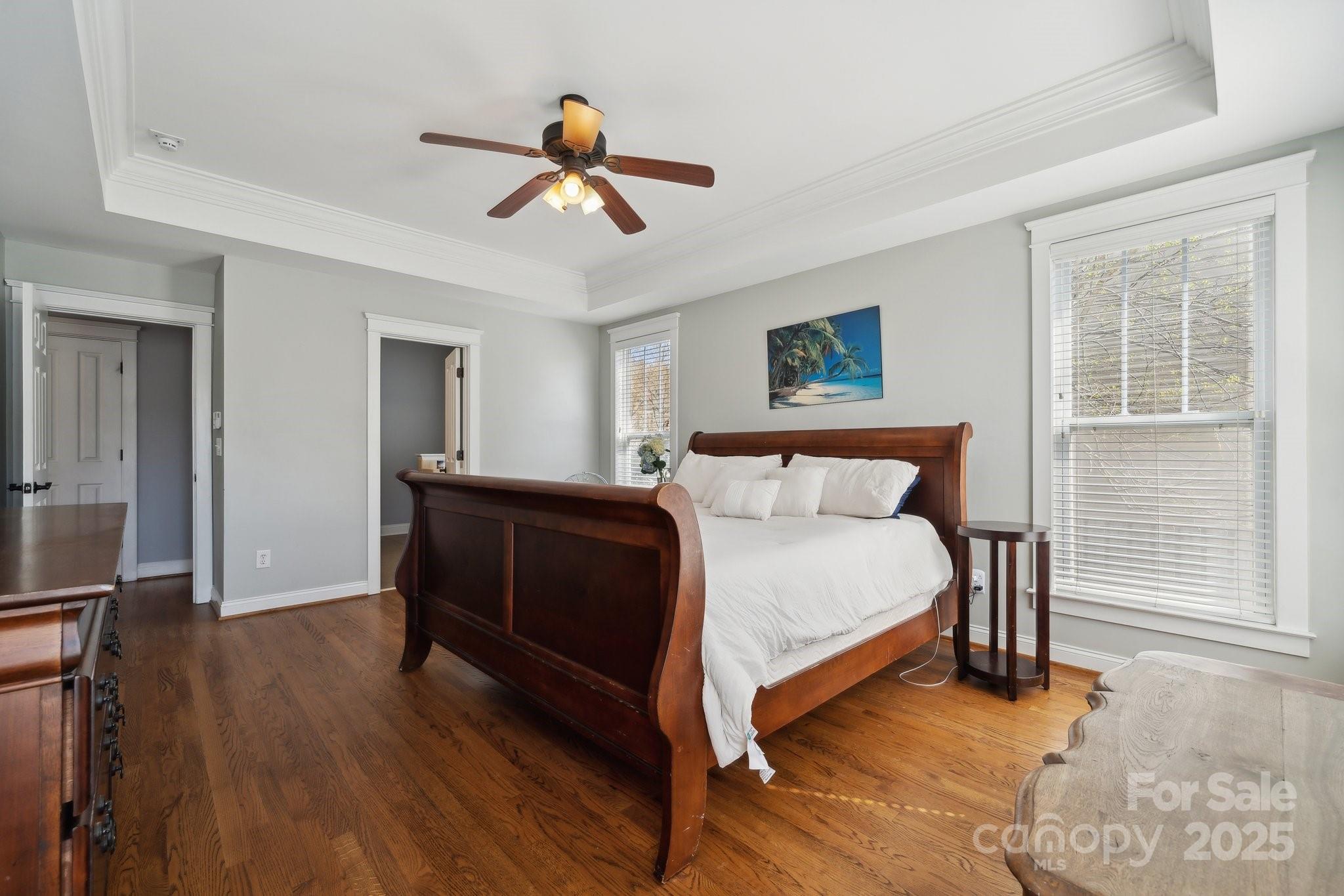 369 Shoreline Parkway Tega Cay, SC 29708 - Photo 17 of 40 a bedroom with a bed and a chandelier