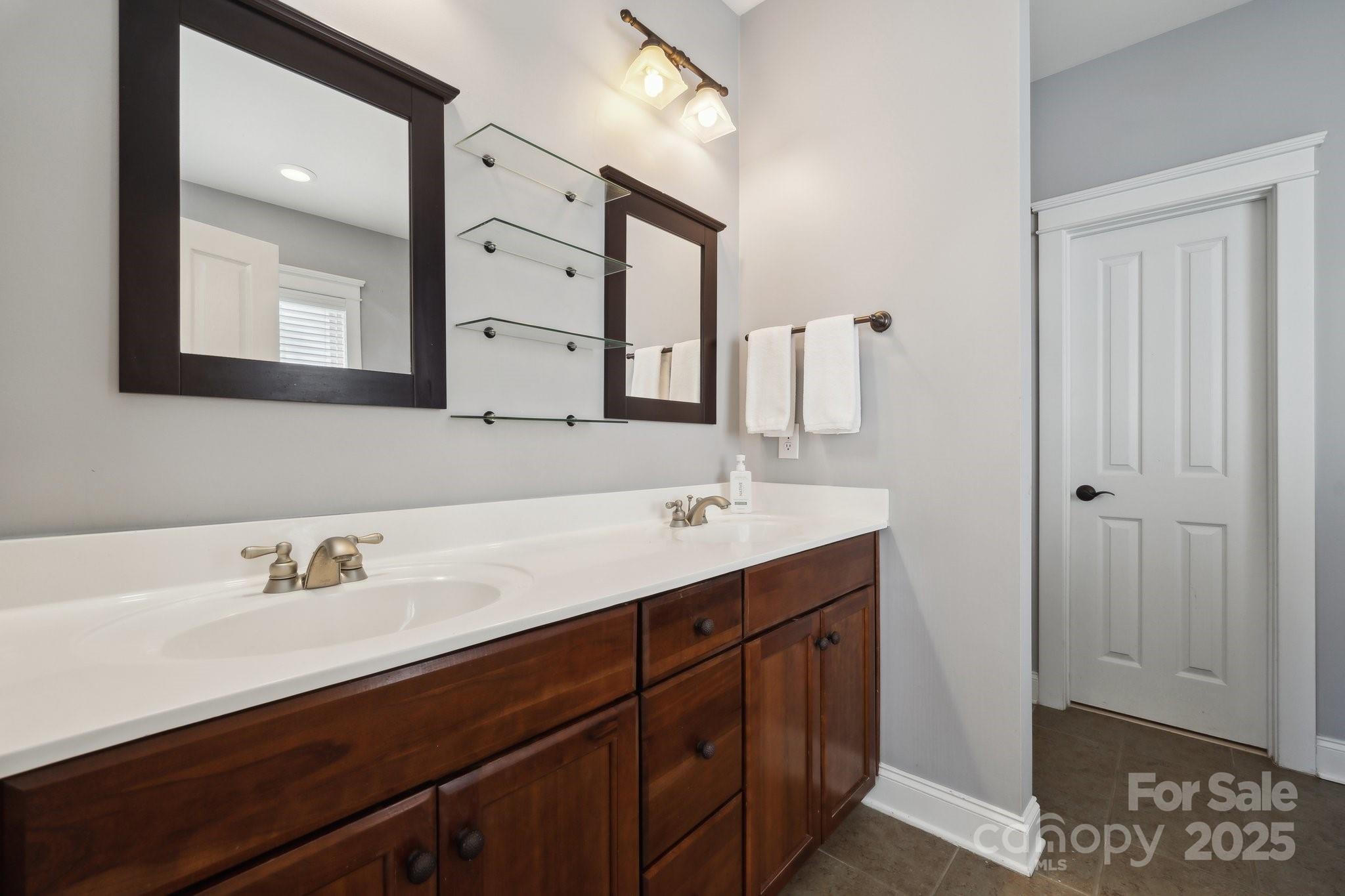 369 Shoreline Parkway Tega Cay, SC 29708 - Photo 18 of 40 a bathroom with a sink vanity and mirror