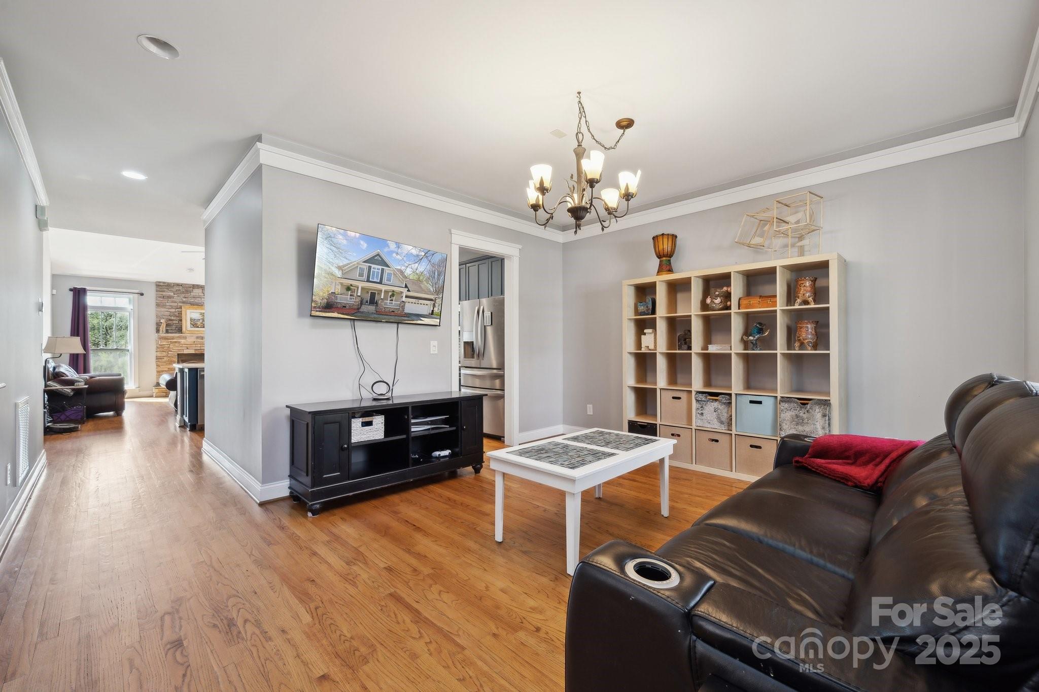 369 Shoreline Parkway Tega Cay, SC 29708 - Photo 3 of 40 a living room with furniture and a chandelier
