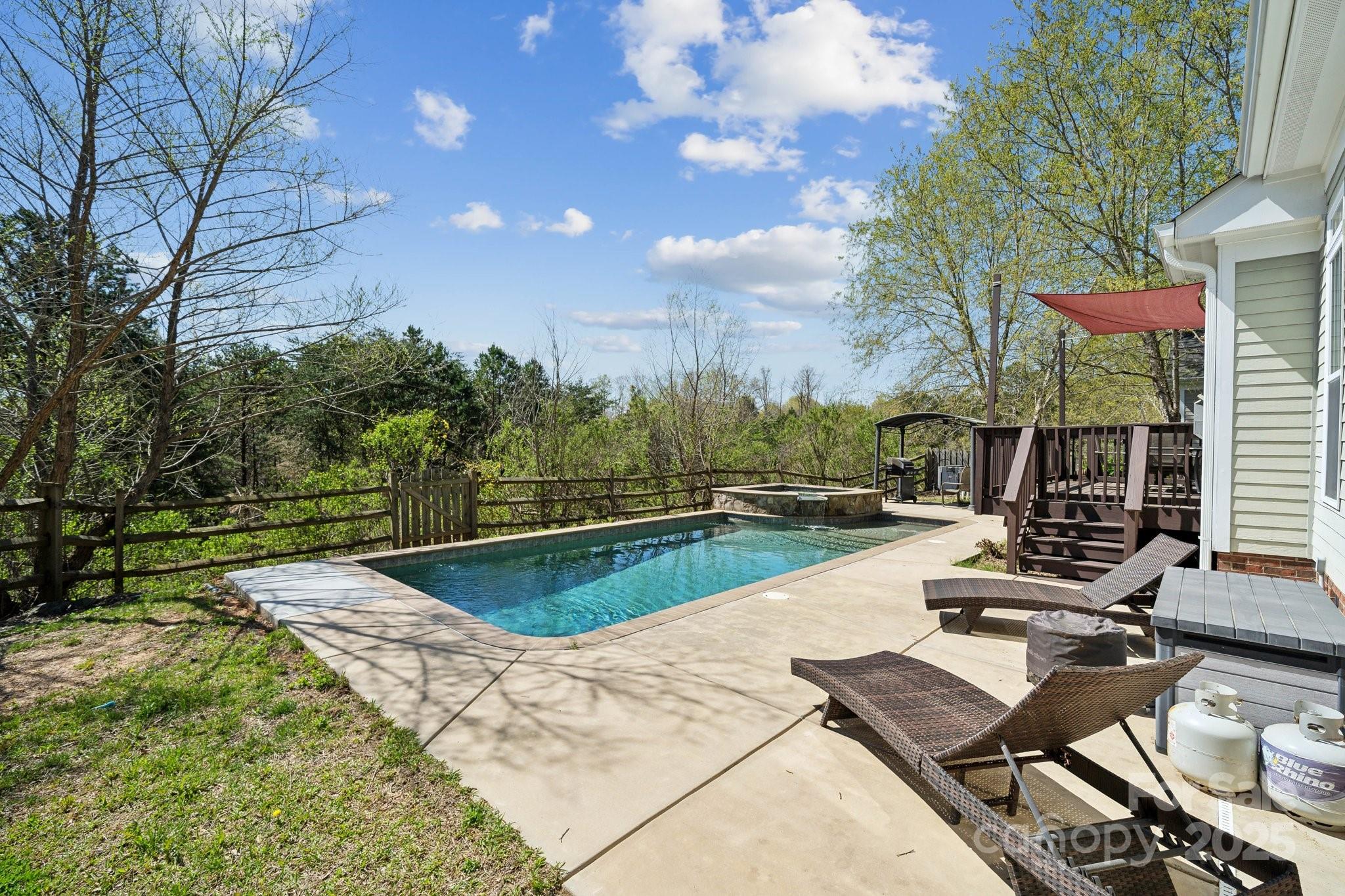 369 Shoreline Parkway Tega Cay, SC 29708 - Photo 34 of 40 a view of a swimming pool with lounge chairs