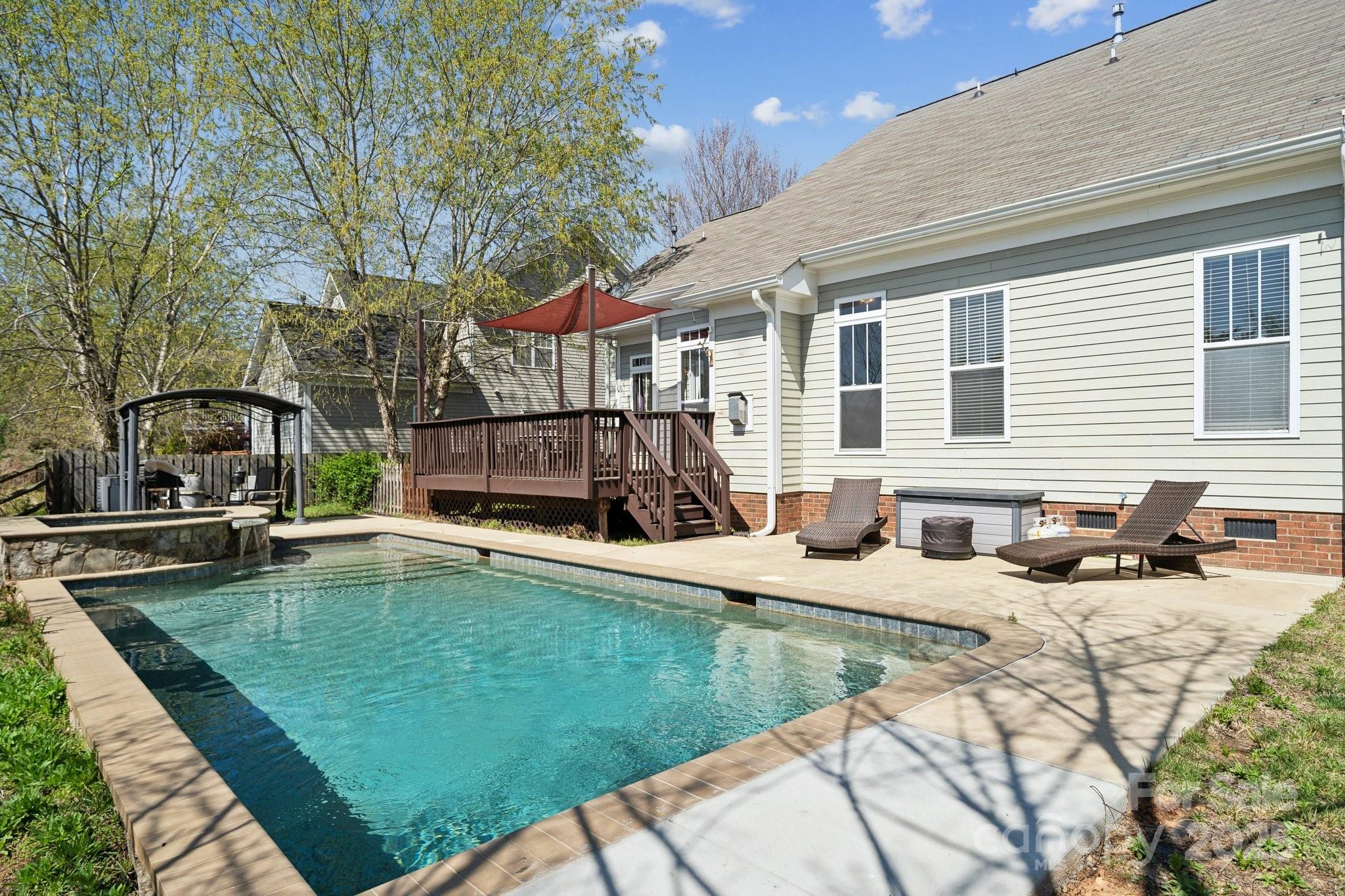 369 Shoreline Parkway Tega Cay, SC 29708 - Photo 35 of 40 a view of a backyard with a patio and fire pit