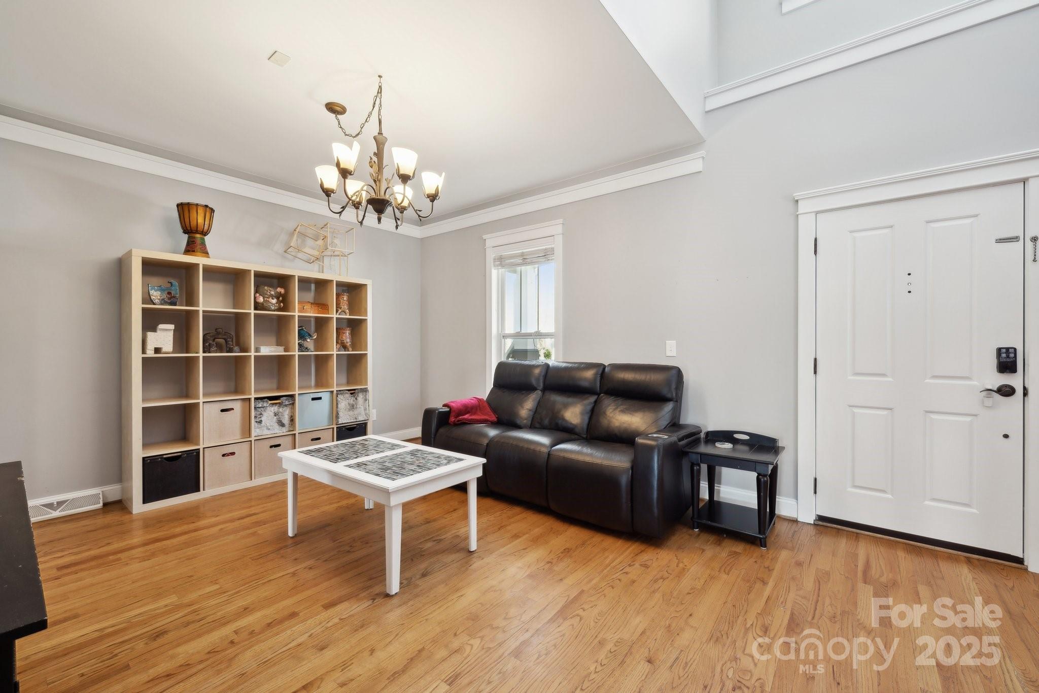 369 Shoreline Parkway Tega Cay, SC 29708 - Photo 4 of 40 a living room with furniture and a chandelier
