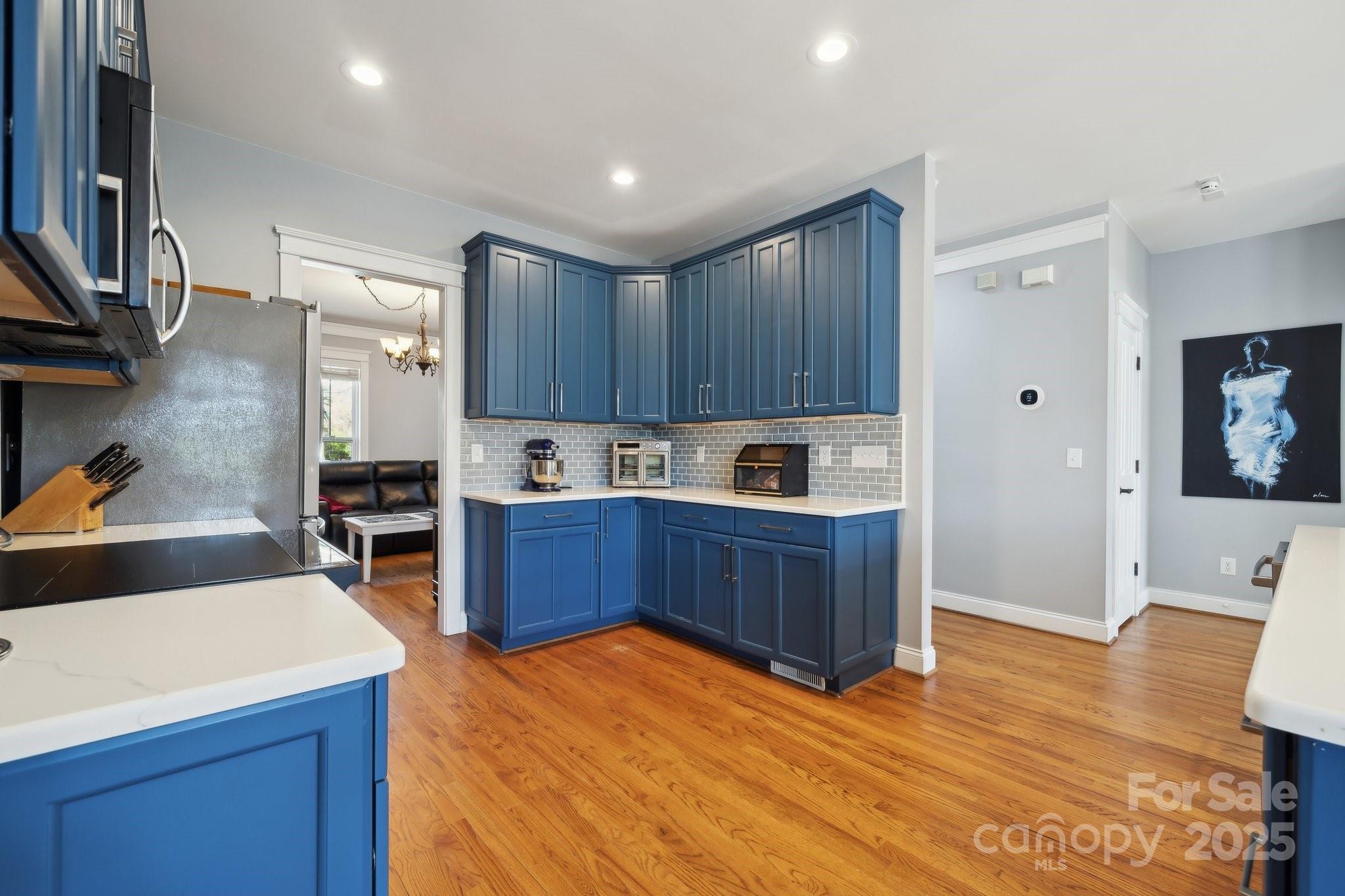369 Shoreline Parkway Tega Cay, SC 29708 - Photo 7 of 40 a kitchen with stainless steel appliances granite countertop a refrigerator sink and wooden cabinets