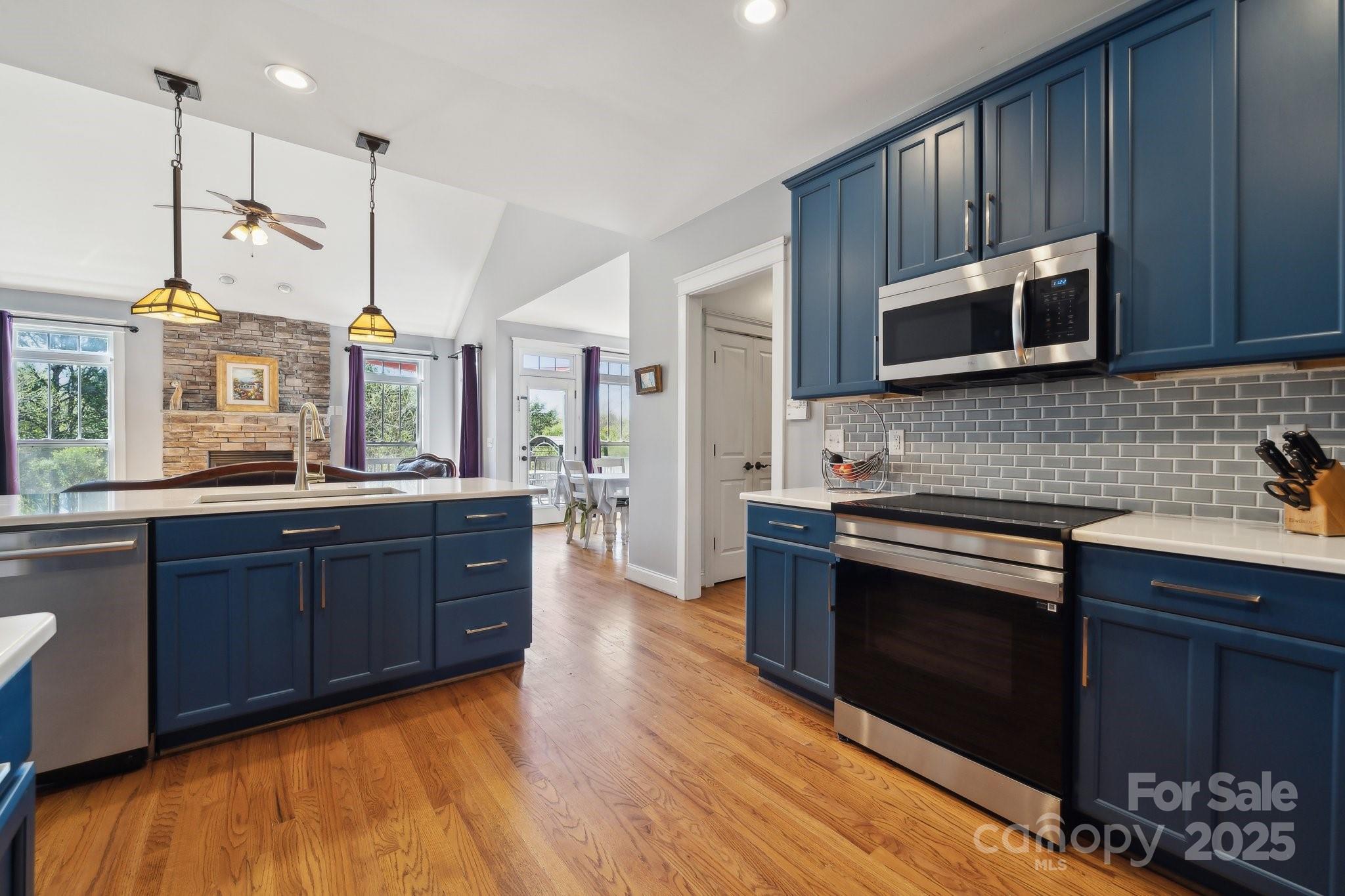 369 Shoreline Parkway Tega Cay, SC 29708 - Photo 8 of 40 a kitchen with stainless steel appliances granite countertop a stove a sink dishwasher a microwave oven with granite countertops and cabinets