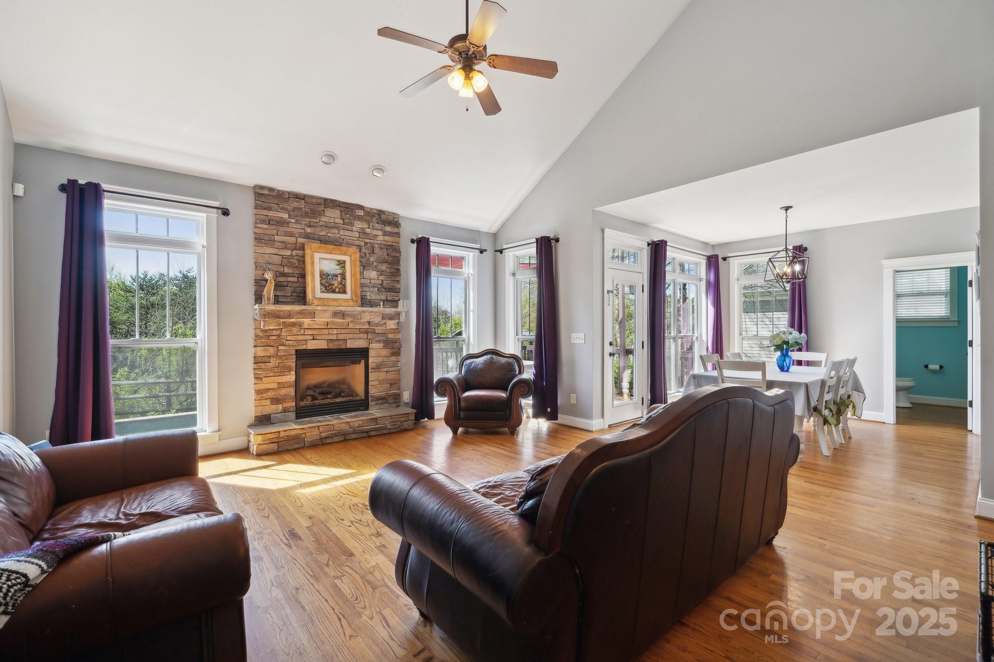 369 Shoreline Parkway Tega Cay, SC 29708 - Photo 9 of 40 a living room with furniture a fireplace and a floor to ceiling window