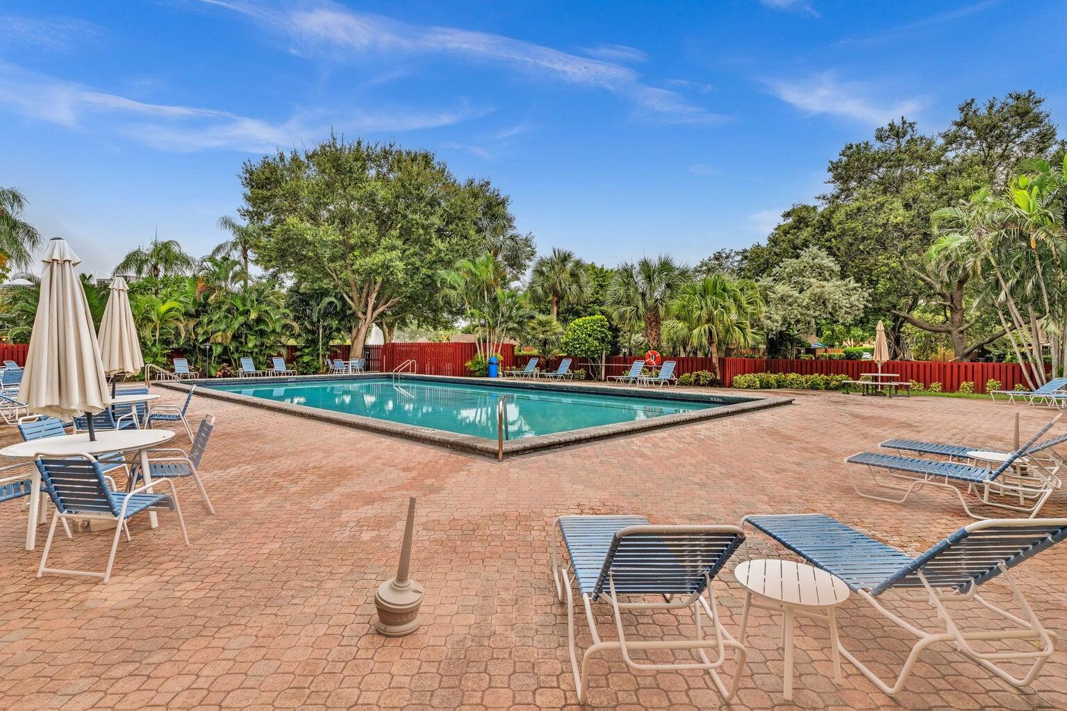 2913 Southwest 22nd Circle, Unit 36D Delray Beach, FL 33445 - Photo 31 of 33 a view of swimming pool with outdoor seating and plants