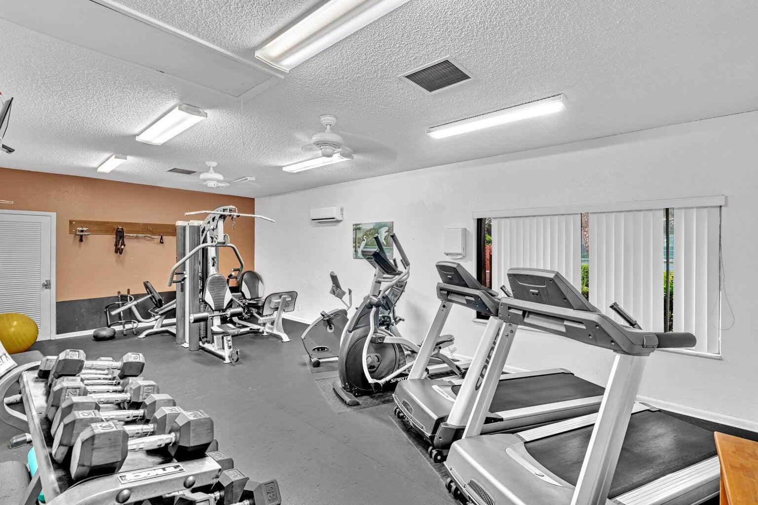 2913 Southwest 22nd Circle, Unit 36D Delray Beach, FL 33445 - Photo 32 of 33 a view of a room with gym equipment