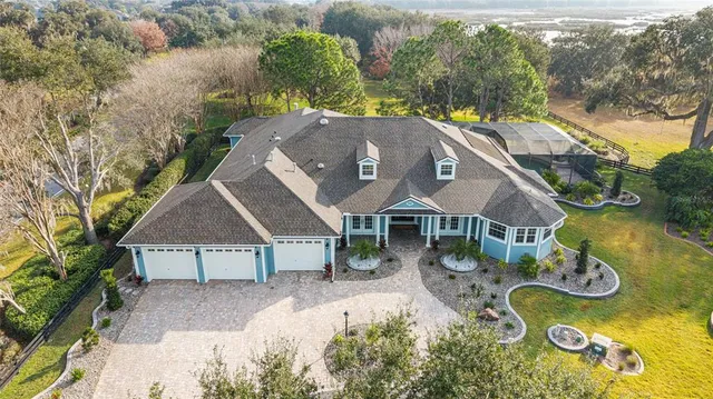 an aerial view of a house with yard swimming pool and outdoor seating
