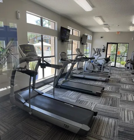 a view of a living room with furniture window and wooden floor