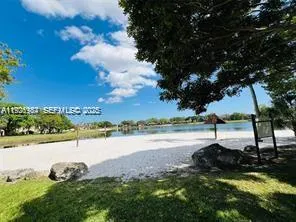 a view of a lake with houses in the background