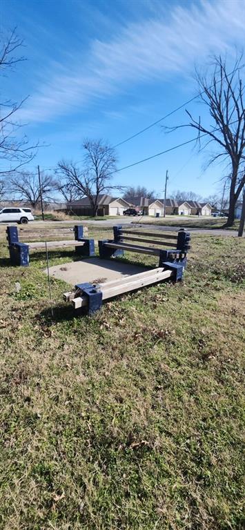 Tbd South Wilson Street Kaufman, TX 75142 - Photo 5 of 6 a view of a backyard with lawn chairs under an umbrella