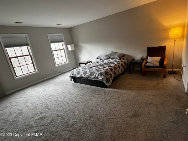 a bed sitting in a bedroom next to a window